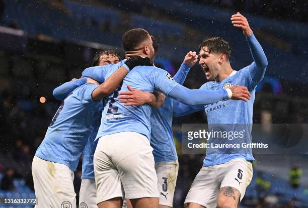 Riyad Mahrez of Manchester City celebrates with Kyle Walker and John Stones after scoring his team's second goal during the UEFA Champions League...