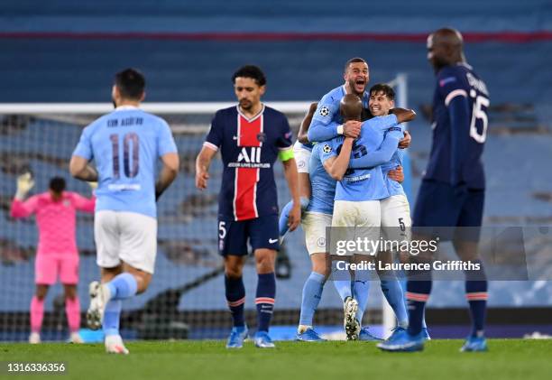 Kyle Walker of Manchester City celebrates victory with Fernandinho and John Stones of Manchester City as Marquinhos and Danilo Pereira of Paris...
