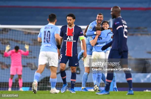 Kyle Walker of Manchester City celebrates victory with Fernandinho and John Stones of Manchester City as Marquinhos and Danilo Pereira of Paris...