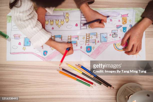 directly above view of lovely little sister drawing and creating artwork together at home - joy concept stock pictures, royalty-free photos & images