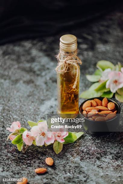 fresh almond oil with almonds and almond flowers - oily skin stock pictures, royalty-free photos & images