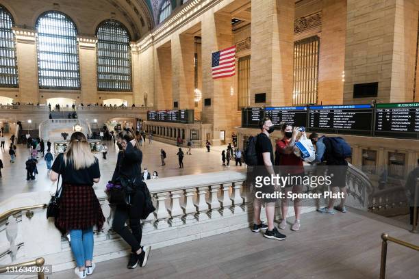People walk through Grand Central Terminal in Manhattan on May 04, 2021 in New York City. Grand Central Terminal, which only months ago was mostly...