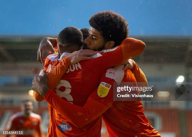 Ellis Simms of Blackpool celebrates scoring their team's second goal with team mates Keshi Anderson and Danny Ballard during the Sky Bet League One...