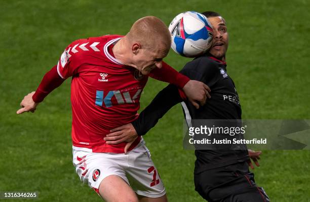 Ben Watson of Charlton Athletic is challenged by Remy Howarth of Lincoln City during the Sky Bet League One match between Charlton Athletic and...