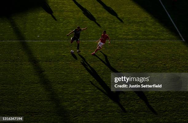 Regan Poole of Lincoln City is challenged by Liam Millar of Charlton Athletic during the Sky Bet League One match between Charlton Athletic and...