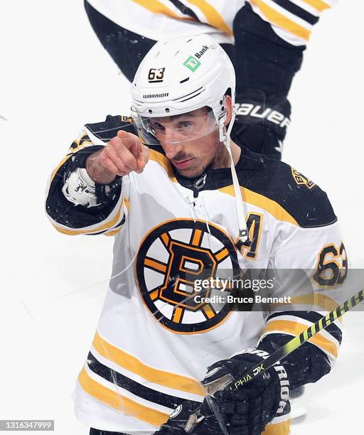Brad Marchand of the Boston Bruins picks out a fan for a puck during warm-ups prior to the game against the New Jersey Devils at the Prudential...