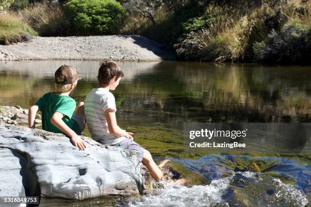 children by river - brook stock pictures, royalty-free photos & images