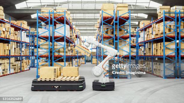 automated robot carriers and robotic arm in modern distribution warehouse - robot stock pictures, royalty-free photos & images