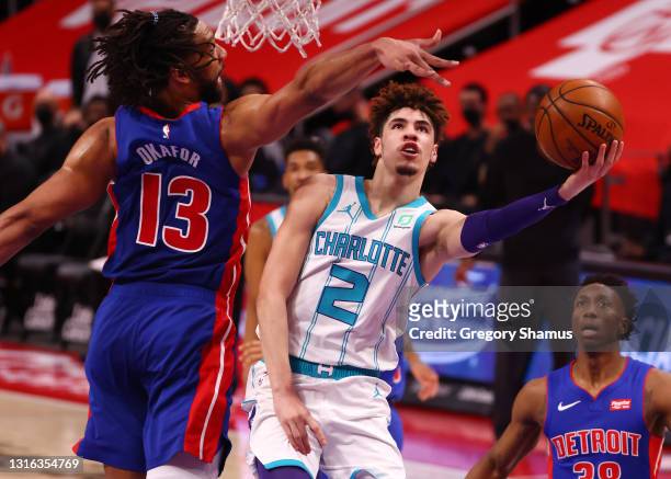 LaMelo Ball of the Charlotte Hornets drives to the basket against Jahlil Okafor of the Detroit Pistons during the first half at Little Caesars Arena...
