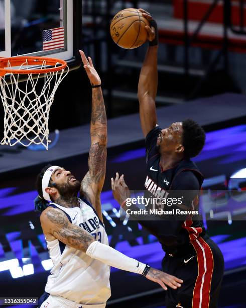 Bam Adebayo of the Miami Heat dunks on Willie Cauley-Stein of the Dallas Mavericks during the first quarter at American Airlines Arena on May 04,...