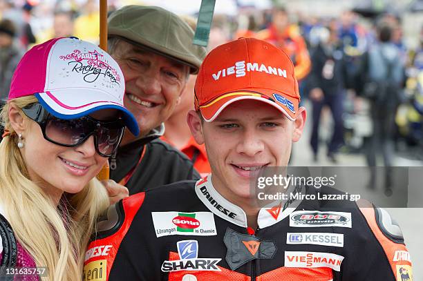 Paris Hilton of USA poses with Stefan Bradl of Germany and Viessmann Kiefer Racing on the grid of MotoGP of Valencia at Ricardo Tormo Circuit on...