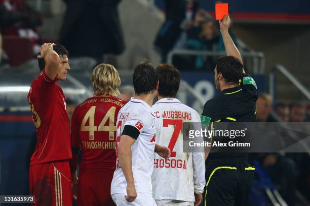 Anatoliy Tymoshchuk of Muenchen is sent oiff by referee Felix Zwayer during the Bundesliga match between FC Augsburg and FC Bayern Muenchen at SGL...
