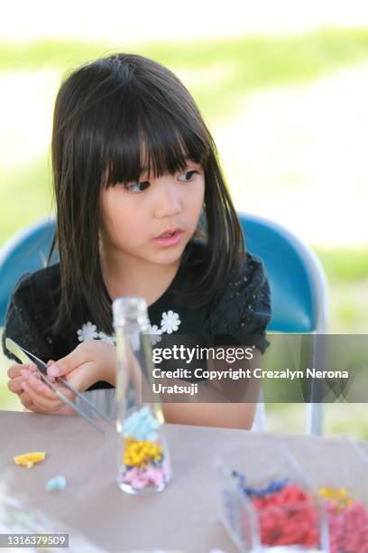 cute little girl craft herbarium - japanese flower arrangement stock pictures, royalty-free photos & images