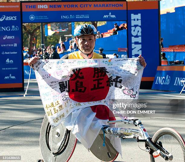 Masazumi Soejima of Japan celebrates his win in the wheelchair division of the ING New York City Marathon November 6, 2011 in New York. AFP PHOTO/DON...