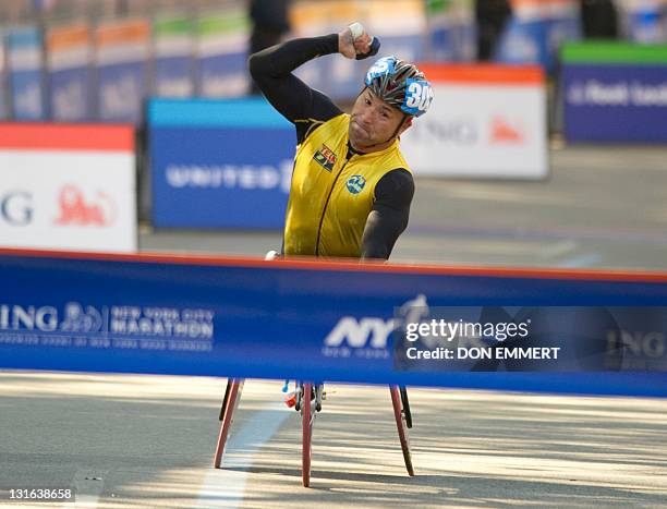 Masazumi Soejima of Japan crosses the finish line to win in the wheelchair division of the ING New York City Marathon November 6, 2011 in New York....