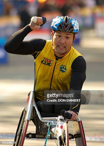 Masazumi Soejima of Japan crosses the finish line to win in the wheelchair division of the ING New York City Marathon November 6, 2011 in New York....
