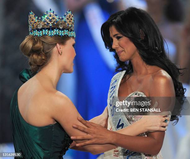 Miss Venezula, Ivian Sarcos , talks to by Miss World 2010, Alexandria Mills of the United States, after winning Miss World 2011 at Earls Court in...