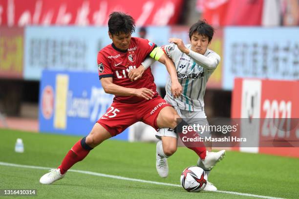 Yasushi Endo of Kashima Antlers and Naoki Wako of Avispa Fukuoka compete for the ball during the J.League YBC Levain Cup Group A match between...