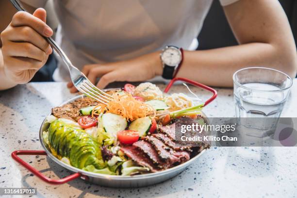 enjoying healthy fruit, vegetable and meat salad with balance nutrition - carbohydrate photos et images de collection