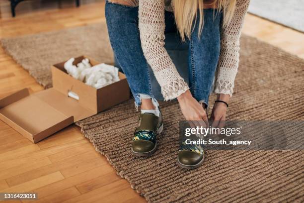 woman trying on shoes - shoes box stock pictures, royalty-free photos & images