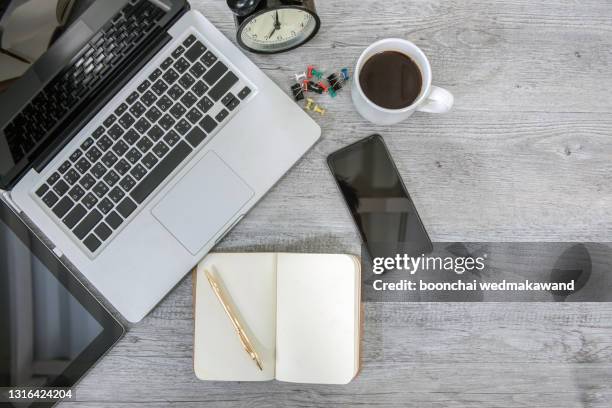 office desk table with blank notebook, computer keyboard and other office supplies. - office desk top view fotografías e imágenes de stock