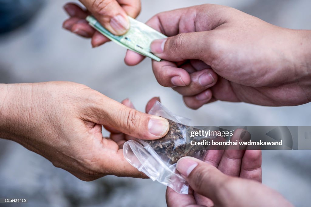 Drug addict buying narcotics and paying.
