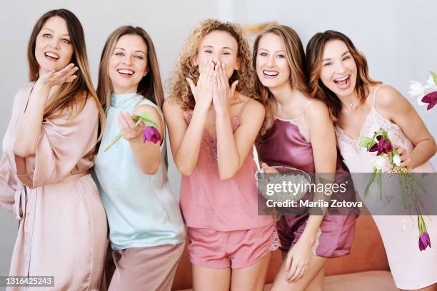 a group of young girls laughing, having fun and celebrating a holiday together - girlfriends party stock-fotos und bilder