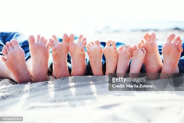 funny feet of a big family on the beach - large family ストックフォトと画像