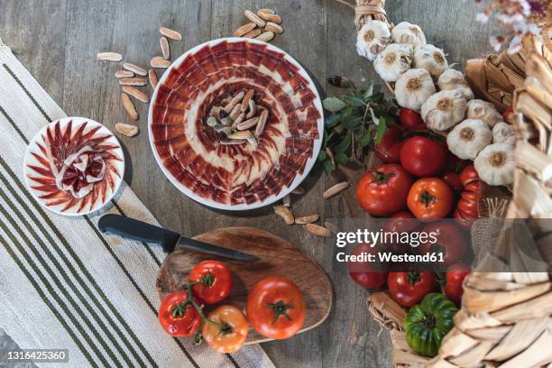 pattern of meat slice in plate by vegetable basket on table - spanish food stock pictures, royalty-free photos & images