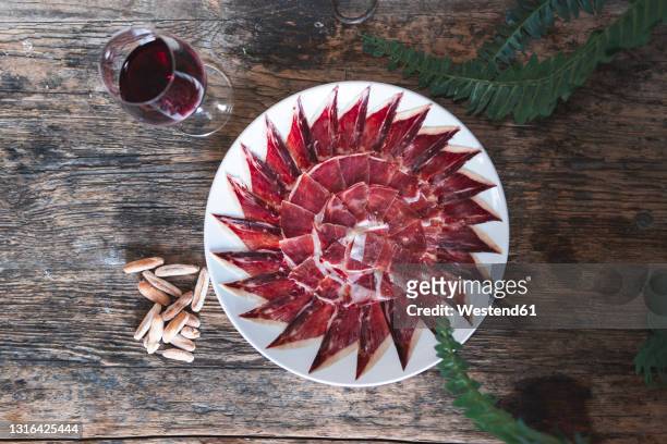 red meat slice arranged in pattern on table by drink - spanish food stock pictures, royalty-free photos & images