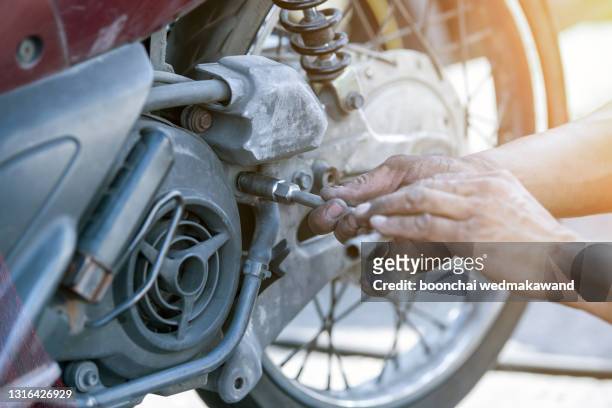 motorcycle repair after a tire leak during a long journey. - dirty car stock-fotos und bilder