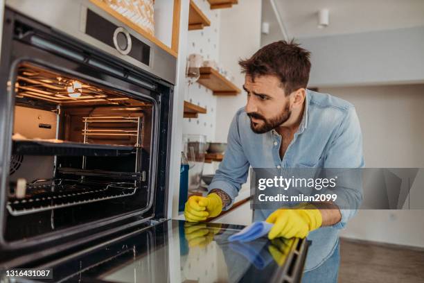 man at home - oven stock pictures, royalty-free photos & images