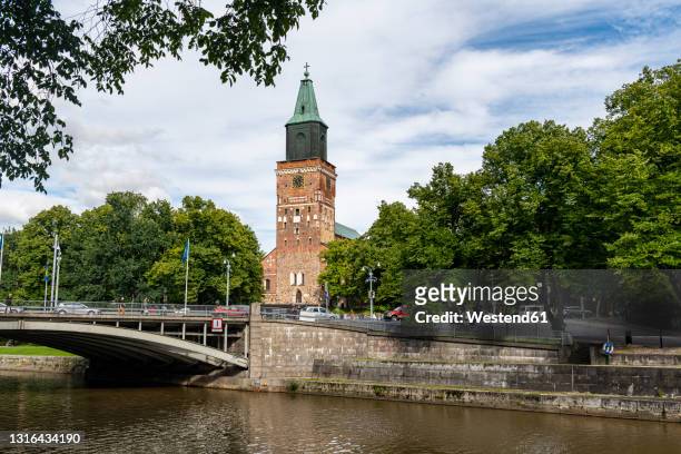 finland, turku, river flowing in front of turku cathedral - turku finland stock pictures, royalty-free photos & images