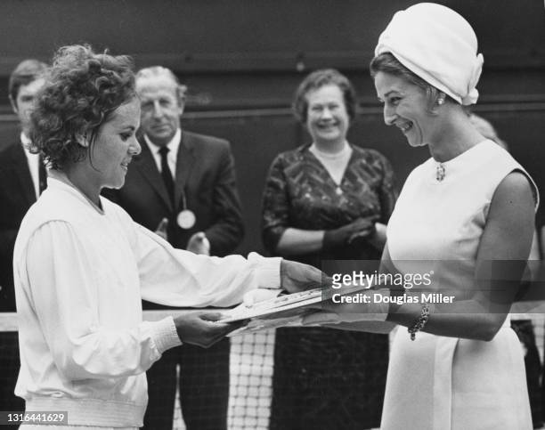 Evonne Goolagong of Australia is presented with the Venus Rosewater Plate by Princess Alexandra after defeating compatriot Margaret Court in their...