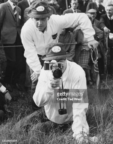 Byron Nelson , the non playing captain of the the United States Ryder Cup team uses a Asahi Pentax SV 35mm SLR camera and a 300mm lens to keep a...