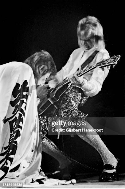 David Bowie, dressed as his Ziggy Stardust character, performs on stage with Mick Ronson of the Spiders From Mars at Earl's Court Arena, London, on...
