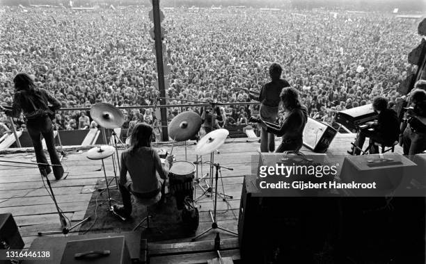 View from the back of the stage behind the drums showing the crowds in the audience watching Stealers Wheel perform at Pink Pop festival, Geleen,...