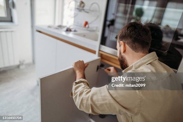 fixing at home hobby - cabinet door stock pictures, royalty-free photos & images