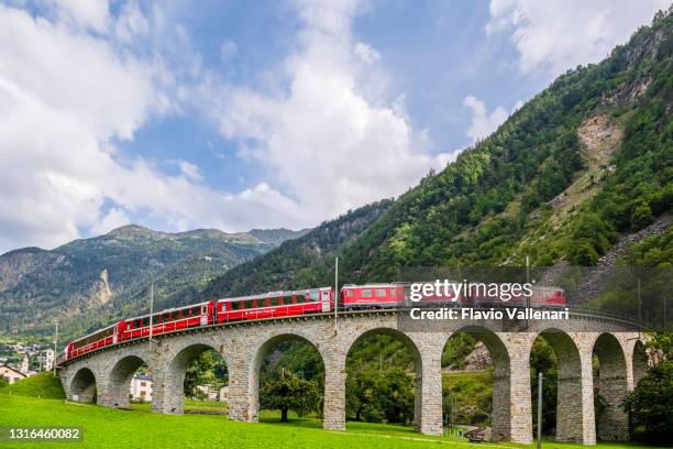 switzerland, red train on the brusio spiral viaduct - brusio grisons stock pictures, royalty-free photos & images