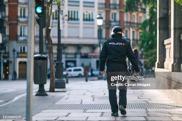 policewoman member of the spanish security forces and bodies walking down a city street - billy walker stock pictures, royalty-free photos & images