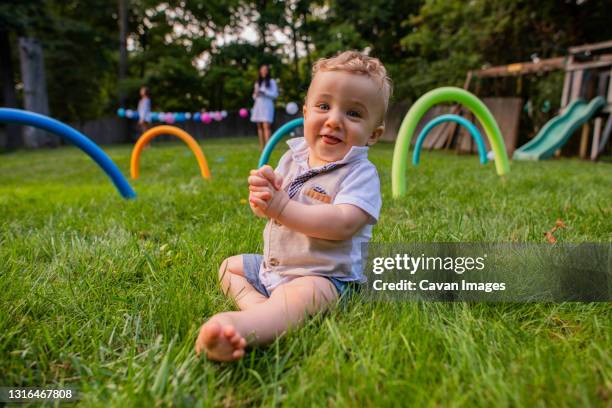 adorable baby sits in yard - backyard cricket stock pictures, royalty-free photos & images