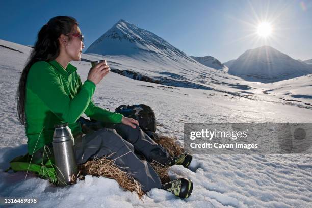 woman having coffee break while hiking in iceland - drinks flask stock pictures, royalty-free photos & images