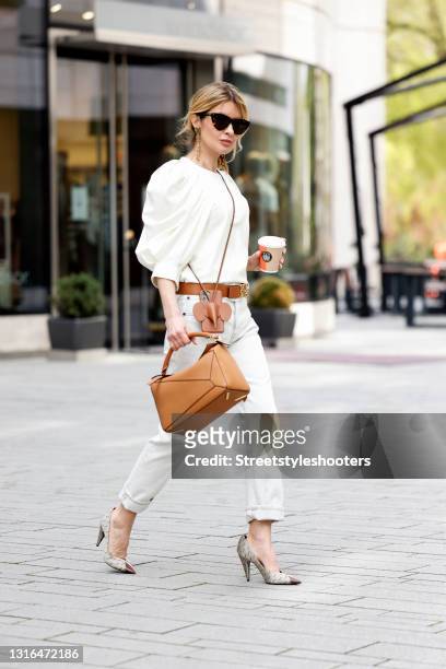 Influencer Gitta Banko wearing a cream colored silk blouse with balloon sleeves by Isabel Marant, cream colored denim jeans pants by Saint Laurent,...