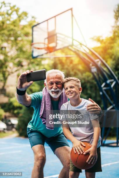 grandfather and grandson on basketball court - family photo shoot stock pictures, royalty-free photos & images