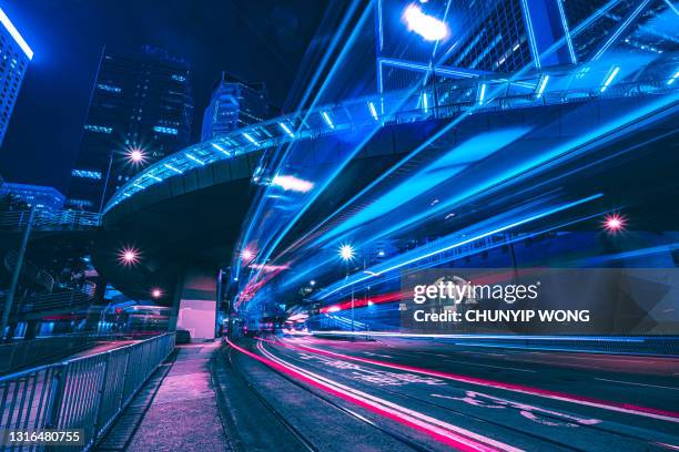 cars traveling trough city in the evening. - smart city stock pictures, royalty-free photos & images