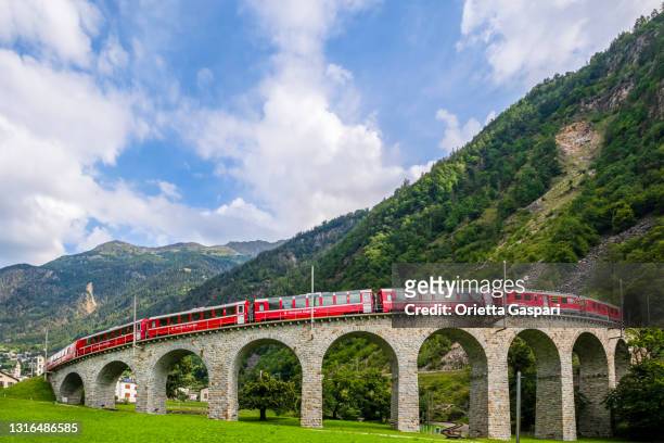 red train on the brusio spiral viaduct,switzerland - brusio grisons stock pictures, royalty-free photos & images