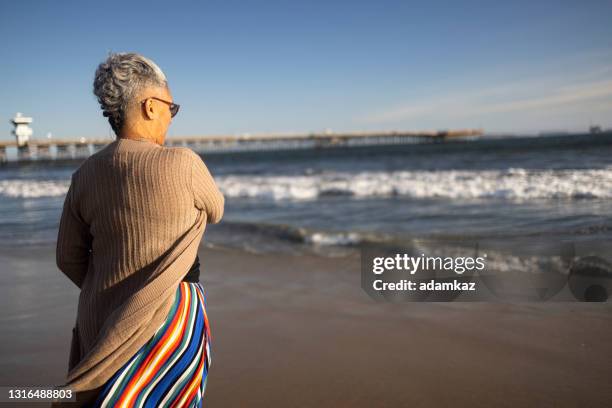 mature black woman at the beach - one senior woman only stock pictures, royalty-free photos & images
