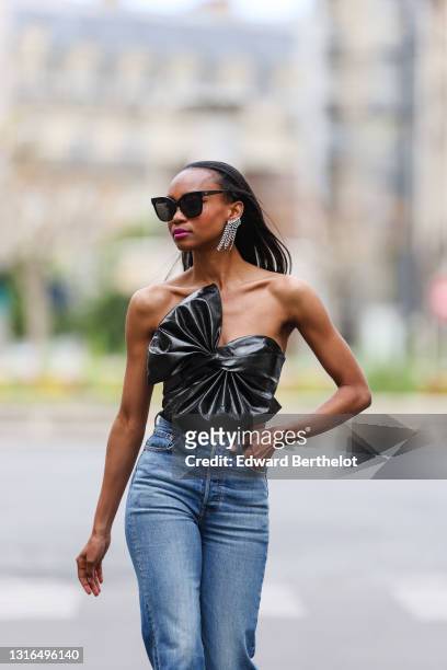 Emilie Joseph @in_fashionwetrust wears a vintage Vinyl bustier/corset top with Maxi bow detail, high waisted ribcage jeans from Levi's, silver and...