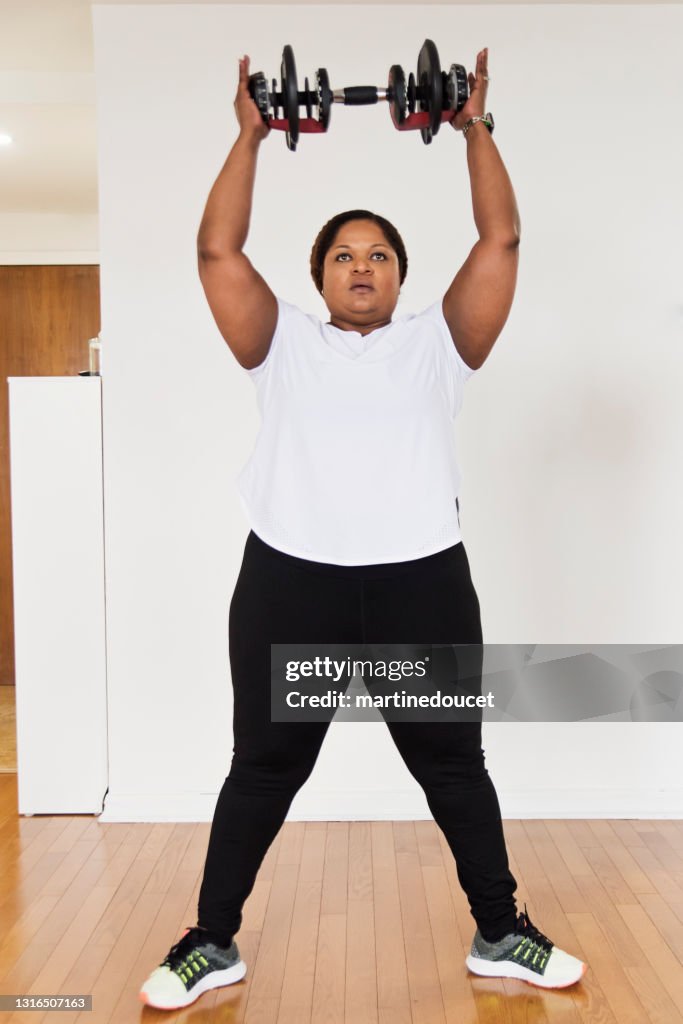 Mature woman doing exercise at home.