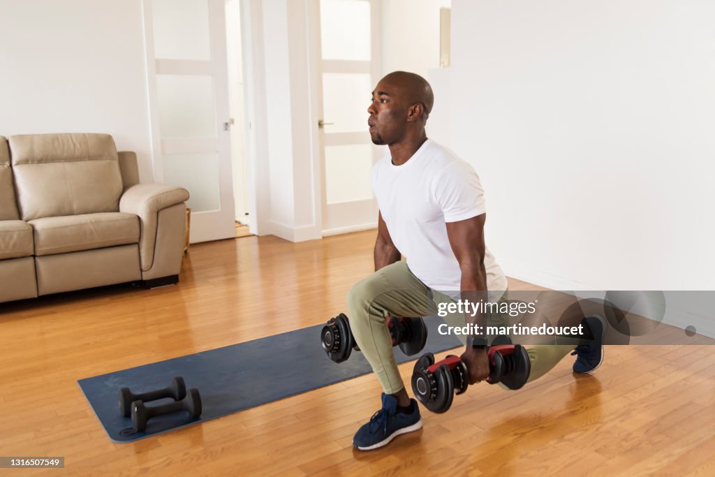 Mature man doing exercise at home.